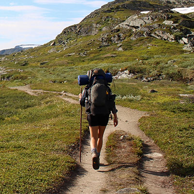 person hiking through wilderness with backpack